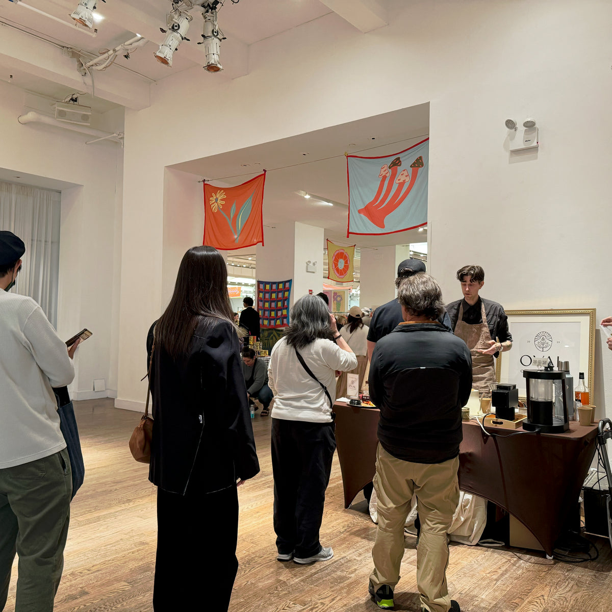 Christopher Alspach serving guests at the Oval Coffee Roasters booth at Renegade Market in Metropolitan Pavilion, New York City.