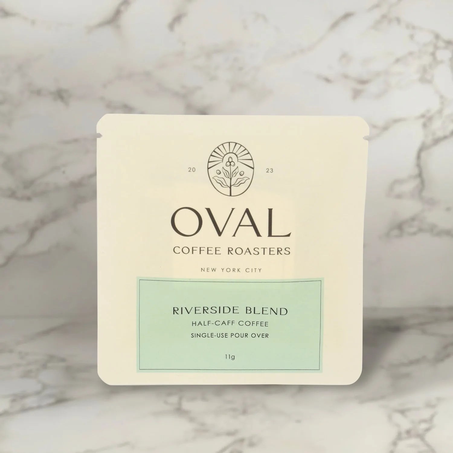 Oval Coffee Roasters Riverside half-caffeinated 11g single-serve pour-over drip filter bag sleeve, light roast coffee roasted in New York City, designed to brew directly over a cup without equipment