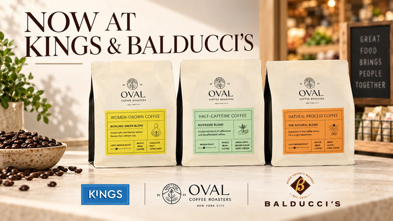 Kings and Balducci’s launch graphic with Oval Coffee Roasters Bowling Green Women-Grown, Riverside Half Caff and The Natural Natural Process whole-bean bags on a countertop beneath “Now at Kings & Balducci’s,” with retailer logos below.
