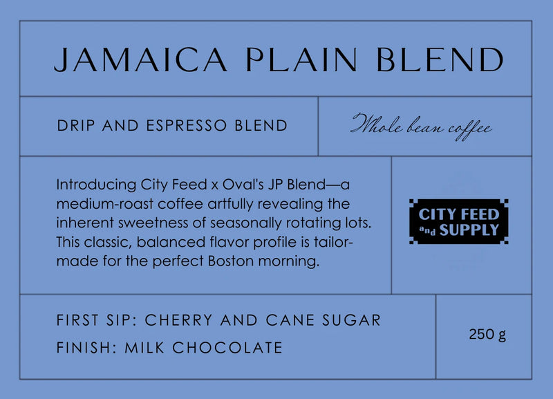 Slate-blue Jamaica Plain Blend label for the City Feed and Supply x Oval whole-bean coffee collaboration, showing a 8.82 oz drip and espresso blend with cherry, cane sugar and milk chocolate tasting notes.