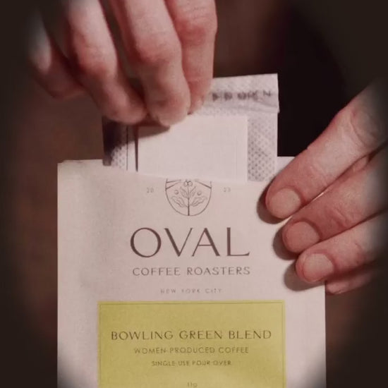 Oval Coffee Roasters Bowling Green Women-Grown pour over single serve coffee brewing over a mug with hot water featuring women-grown light roast specialty coffee.