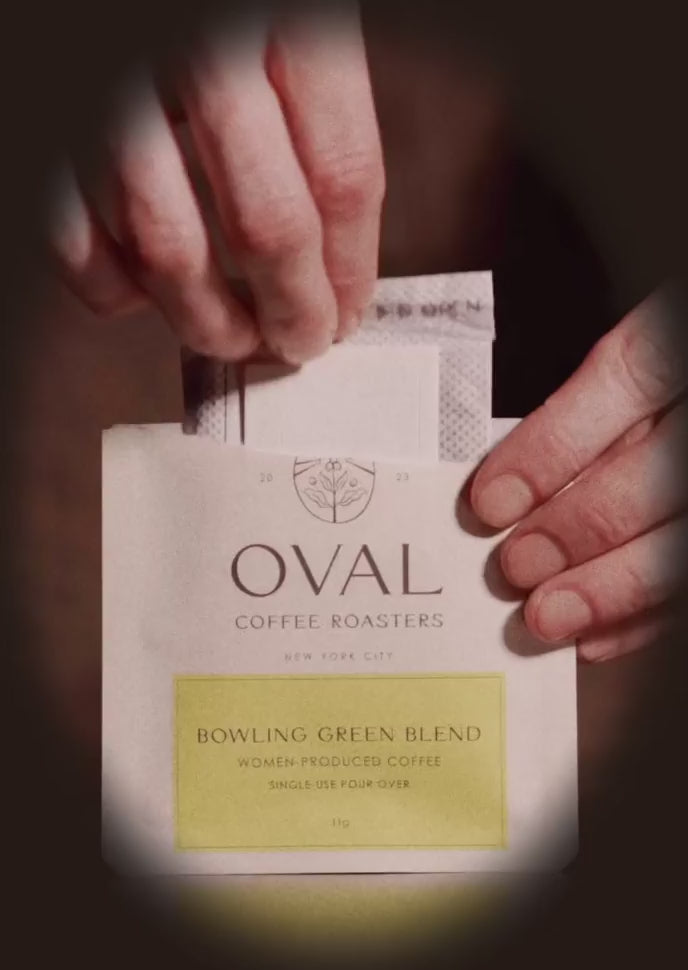 Oval Coffee Roasters Bowling Green Women-Grown pour over single serve coffee brewing over a mug with hot water featuring women-grown light roast specialty coffee.